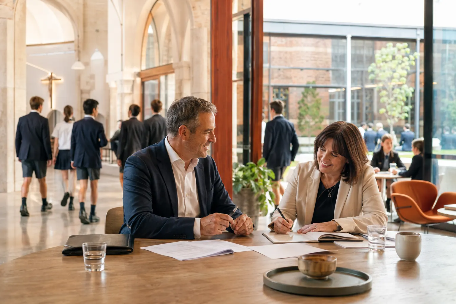 A board chair closes a meeting while the secretary records the final resolution; papers settle in the sharp centre as departing members create restrained movement at the edges.